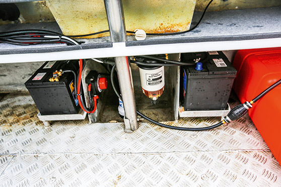 New Century marine batteries, battery switch and fuel filter were added under the transom.