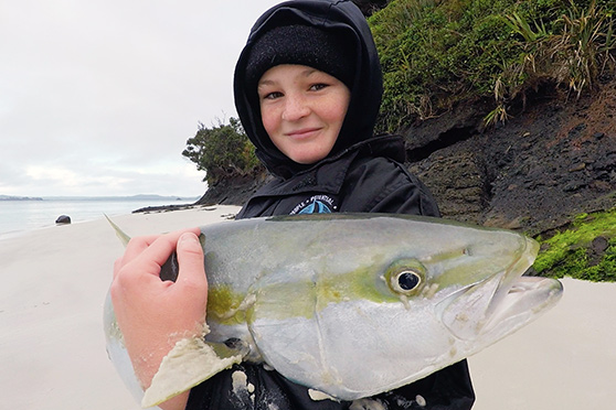 Blake's kingfish safely in his arms after a fantastic shore-based effort.