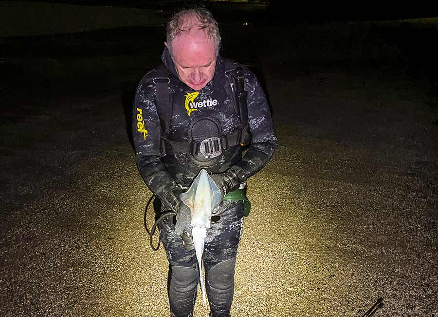Barry Baxter examining his catch.