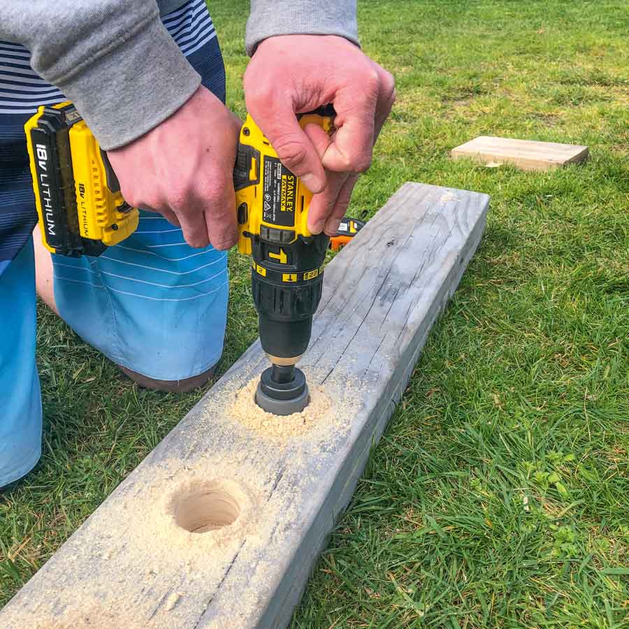 A hole saw was used to drill holes in the top board.