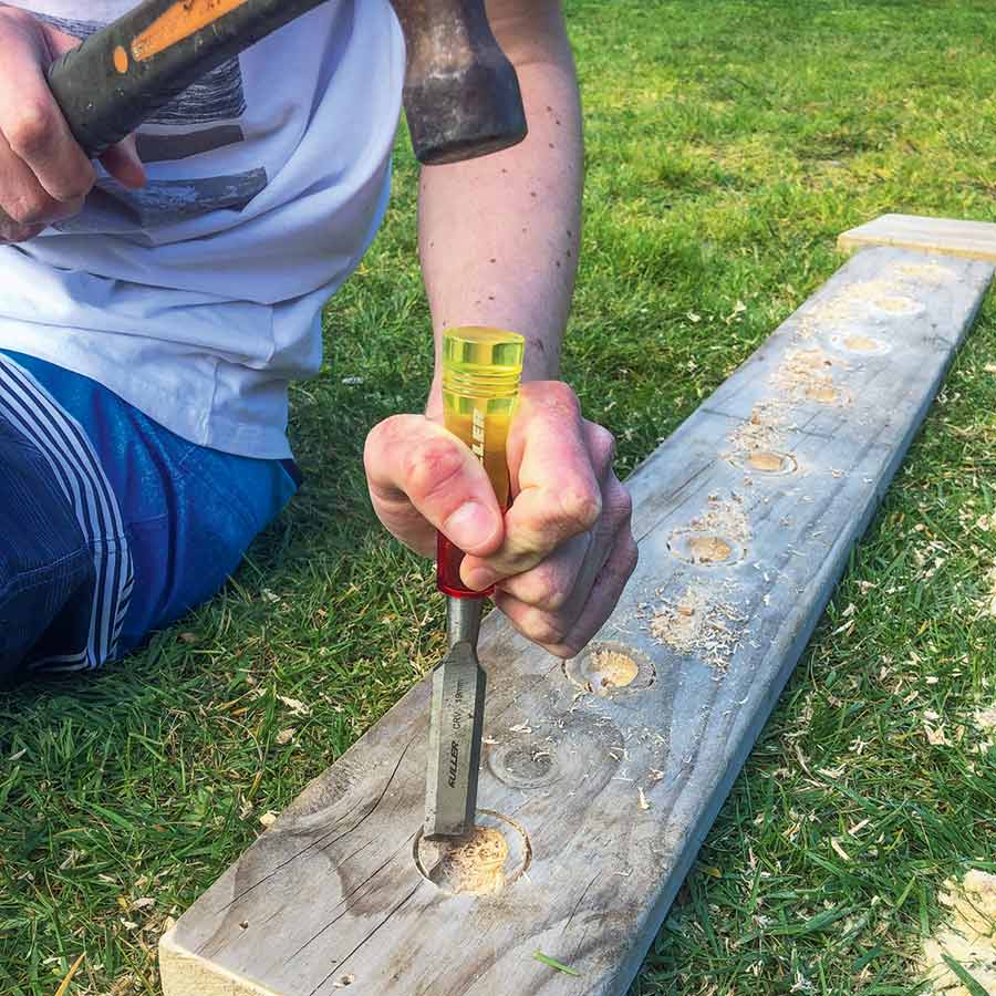 Hayden chiselling out of the hollows made in the bottom board.