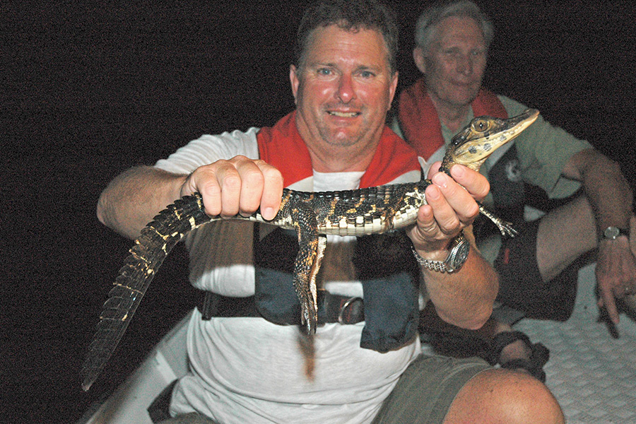 Black caiman in the Amazon are not very aggressive. Sam with a yearling.
